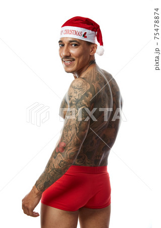 Portrait of athletic smiling tattooed guy. Studio shot, isolated Portrait of athletic smiling tattooed guy. Studio shot, isolated 75478874