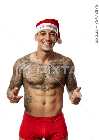 Portrait of athletic smiling tattooed guy. Studio shot, isolated 75478875