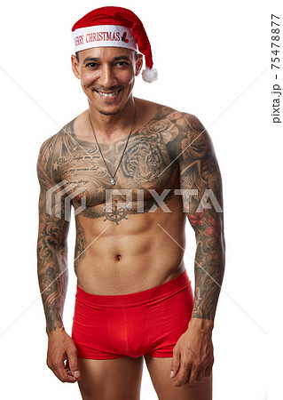 Portrait of athletic smiling tattooed guy. Studio shot, isolated Portrait of athletic smiling tattooed guy. Studio shot, isolated 75478877