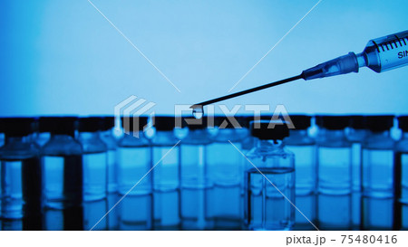 Vaccine bottles and syringe injection. Medicine in ampoules. Glass vials for liquid samples in laboratory. 75480416