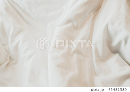 Top view of White duvet on the bed with sunlight. Bedroom with white bed. 75481580