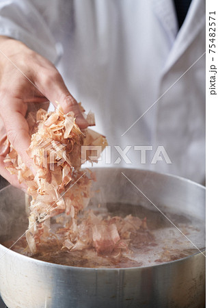 鰹節を鍋に入れる板前 鰹節を鍋に入れる板前 75482571