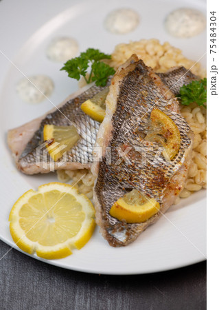 Lemon-spiked sea bream fillet, cooked wheat risotto  75484304