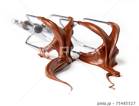 whisk whit melted chocolate cream isolated on white background, selective focus 75485527