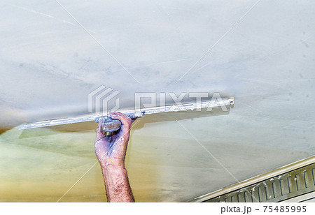 putty; filler; coating; filling; plasterer man; renovation home; architecture; builder; building; cement; concrete; development; engineering; filler; filling; finishing; foreman; gypsum; gypsum plaste 75485995
