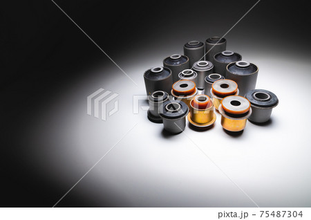 A set of new rubber and polyurethane silent blocks for an SUV on a gradient background. 75487304