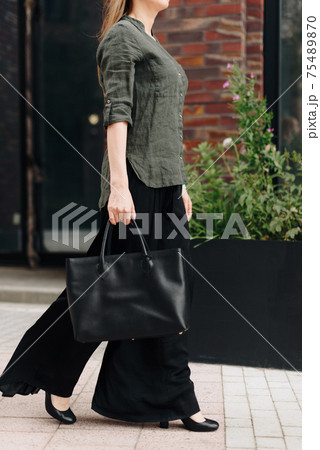 A woman with a bag on the background of the city 75489870