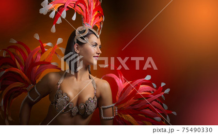 Beautiful woman in carnival costume with natural feathers and rhinestones. 75490330