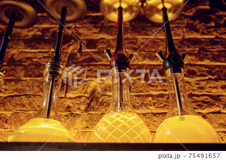 A row of hookahs with glass bulbs, nobody A row of hookahs with glass bulbs, nobody 75491657