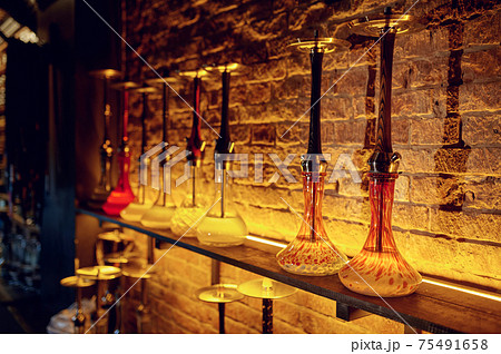 A row of hookahs with glass bulbs, nobody A row of hookahs with glass bulbs, nobody 75491658