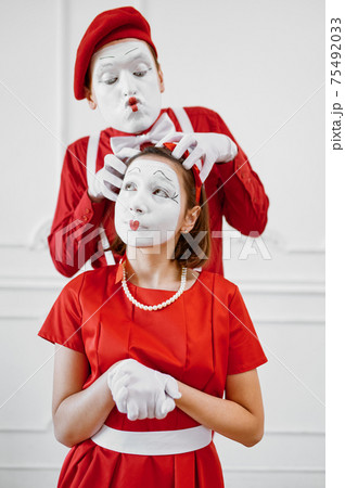 Two mime artists with face and hand makeup 75492033