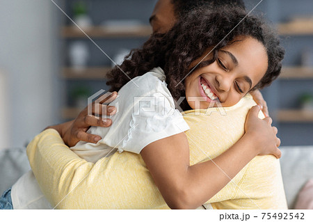 Emotional african american girl hugging her dad, closeup 75492542