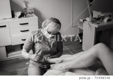 Photo of the professional pedicure process with the model Photo of the professional pedicure process with the model 75498546