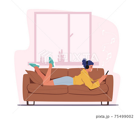 Young Woman Lying on Sofa with Smartphone in Hands Listen Music in Headphones, Relax at Home. Female Character Relaxing Young Woman Lying on Sofa with Smartphone in Hands Listen Music in Headphones, Relax at Home. Female Character Relaxing 75499002