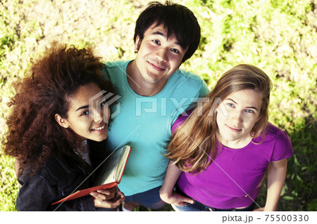 cute group of teenages at the building of university with books huggings, diversity nations, having lunch cute group of teenages at the building of university with books huggings, diversity nations, having lunch 75500330