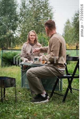 A delicious kebab was prepared by a man for his wife. A young couple retired on vacation in a country house to spend time together. 75500916