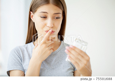 A healthy young woman refuses to take a cigarette from a pack. 75501688