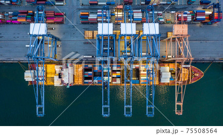 Aerial view container ship loaded in container terminal at night, Global business import export logistic and transportation, Commercial dock company cargo vessel freight shipping at night. 75508564