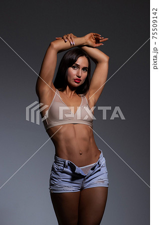 Voluptuous woman in underwear standing gracefully in studio 75509142