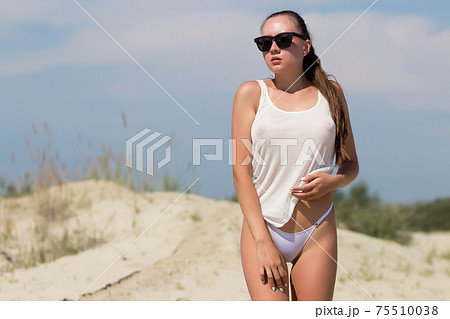 Sexy woman on windy day on beach Stock Photo [75510038] - PIXTA