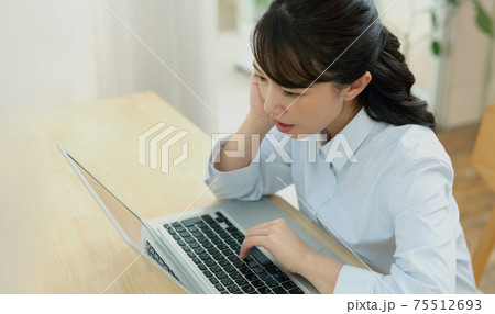 パソコンと悩む女性 75512693