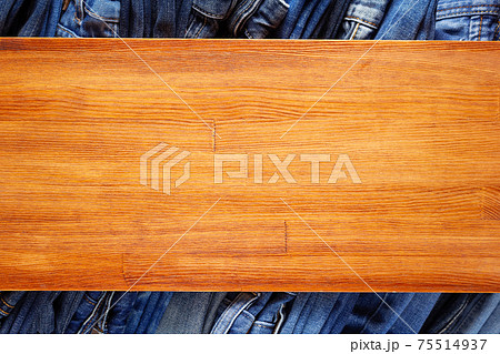 Denim jeans on old wooden background texture table surface Denim jeans on old wooden background texture table surface 75514937