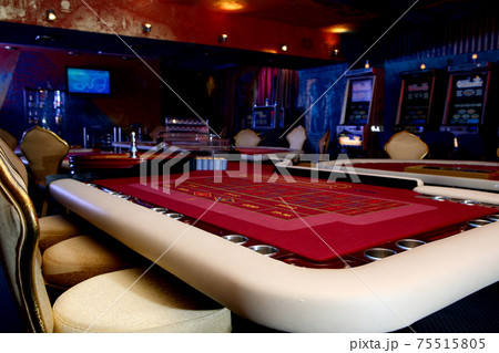 Table with roulette. Gaming hall in the casino Table with roulette. Gaming hall in the casino 75515805