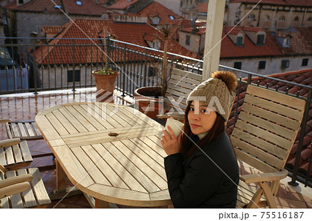 girl have coffee on the balcony girl have coffee on the balcony 75516187