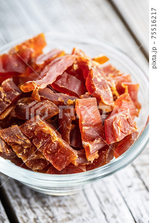 Dried chicken meat. Tasty jerky meat. 75516217