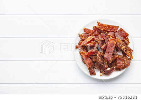 Dried chicken meat. Tasty jerky meat. Dried chicken meat. Tasty jerky meat. 75516221