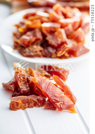 Dried chicken meat. Tasty jerky meat. 75516223