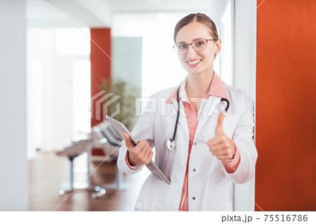 Doctor woman in her practice giving a thumbs up Doctor woman in her practice giving a thumbs up 75516786
