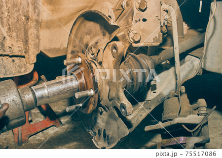 Car Mechanic or Auto Mechanic Tighten Drive Axle Shaft Hub Nut by Wind Block in Vintage Tone 75517086