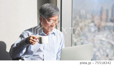 man use laptop near window 75518342