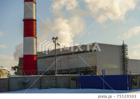 Industrial building of power plant with pipe behind the fence Industrial building of power plant with pipe behind the fence 75520503