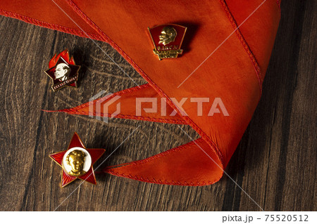 Badges of Soviet pioneers and komsomol with a portrait of Lenin on pioneer tie Badges of Soviet pioneers and komsomol with a portrait of Lenin on pioneer tie 75520512