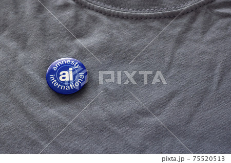 Badge of Amnesty International, human rights organization on shirt 75520513