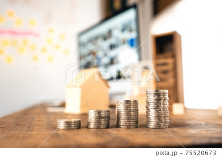 Money coin Grow up business and computer Concept,Silver coins stacked on wooden desks. 75520673