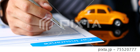 Male arm in suit sign insurance form lying on table Male arm in suit sign insurance form lying on table 75520777