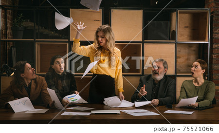 Young colleagues working together in a office styled like classical artworks. Look busy, attented, cheerful, successful. Concept of business, office, finance. 75521066