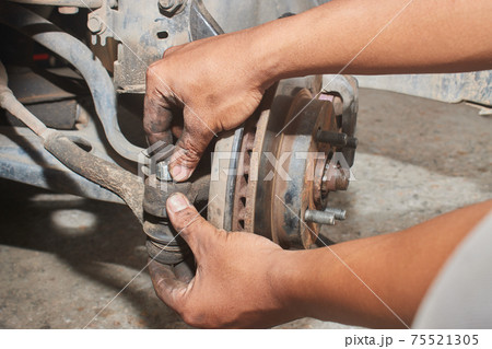 Car Mechanic or Auto Mechanic Tighten Castle Nut or Crown Nut Car Mechanic or Auto Mechanic Tighten Castle Nut or Crown Nut 75521305