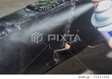 Zoom View Auto Mechanic Spray Paint to Weld at Side of Car Chassis Zoom View Auto Mechanic Spray Paint to Weld at Side of Car Chassis 75521330
