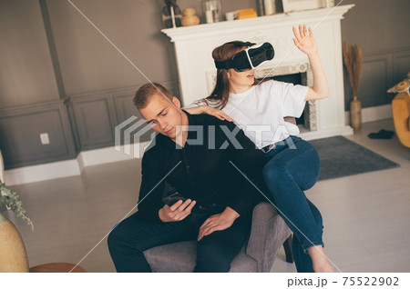 Young man and woman Using VR In The Living Room Young man and woman Using VR In The Living Room 75522902