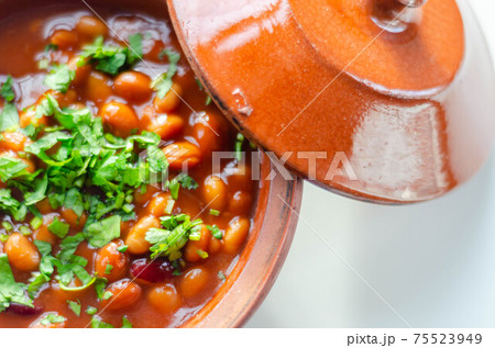 A hearty serving of baked beans in a ceramic dish, a healthy and nutritious meal 75523949