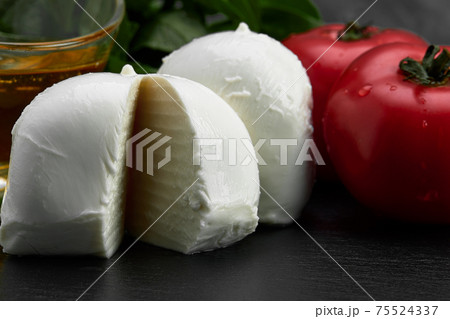 Fresh handmade soft Italian cheese from Campania, white balls of buffalo mozzarella cheese made from cow milk ready to eat close up Fresh handmade soft Italian cheese from Campania, white balls of buffalo mozzarella cheese made from cow milk ready to eat close up 75524337