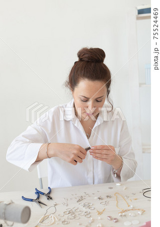 Professional jewelry designer making handmade jewelry in studio workshop. Fashion, creativity and handmade concept 75524469