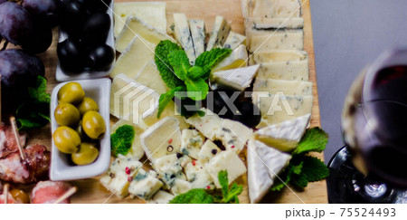 set of different cheeses on a wooden board, cheese board, delicious snack, healthy and exclusive food set of different cheeses on a wooden board, cheese board, delicious snack, healthy and exclusive food 75524493