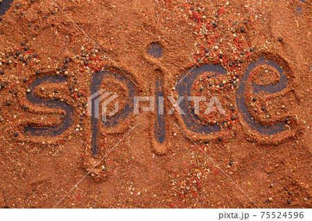 Top view of the inscription spices made from red capsicum ground pepper and cinnamon on the table. Spicy food concept and oriental cuisine Top view of the inscription spices made from red capsicum ground pepper and cinnamon on the table. Spicy food concept and oriental cuisine 75524596