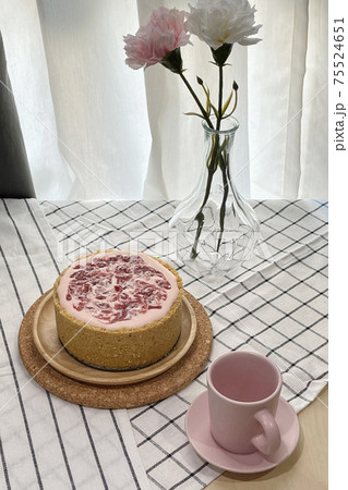 Yogurt strawberry cheesecake decorate with empty pink coffee shot cup and rose flowers. 75524651