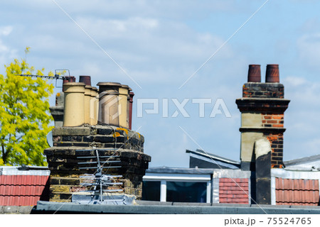 Typical English chimneys on the roofs of London buildings Typical English chimneys on the roofs of London buildings 75524765